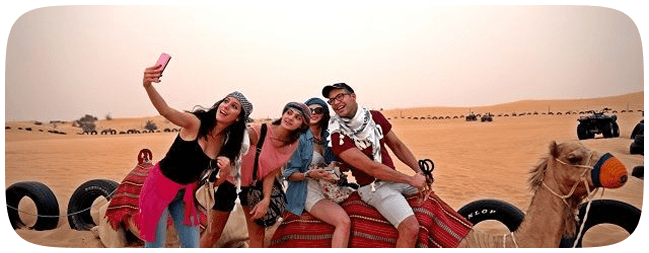 Group taking selfie on camel